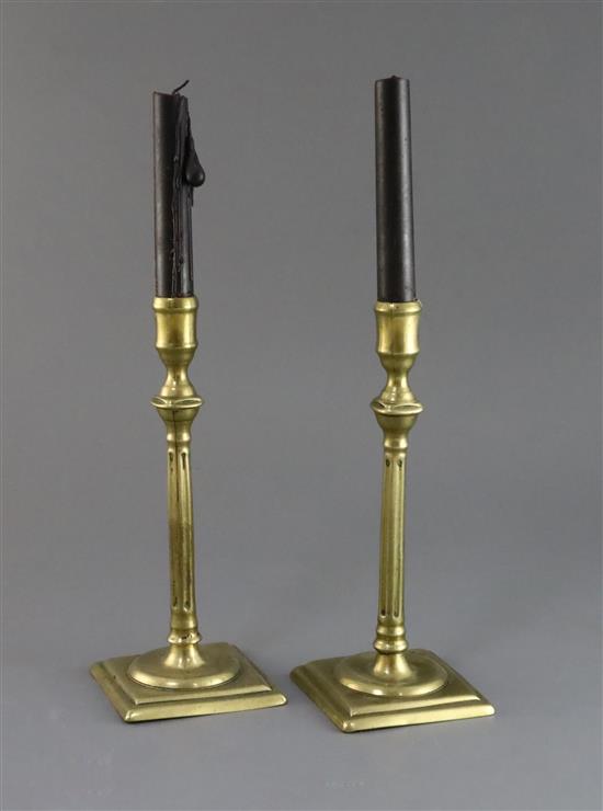 A pair of mid 18th century brass candlesticks, 9in.